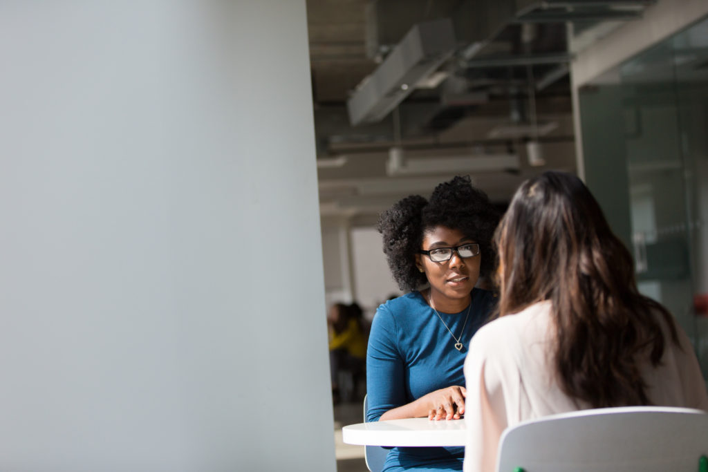 women speaking at an office